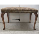 A 1930s walnut framed stool with a tapestry upholstered top, raised on cabriole legs