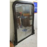 A late Victorian mirror, the shaped plate set in an overpainted pine frame  67" x 57"