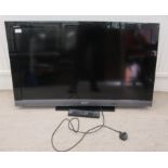 A Sony Bravia 38" television, on a stand with a remote control