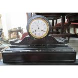 A late Victorian slate cased mantel clock; faced by a Roman dial, on a plinth  11"h  17"w