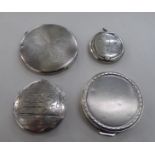 Four silver and white metal powder compacts; and similar cases