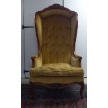 A modern stained beech showwood framed, hall style porters chair, button upholstered in gold