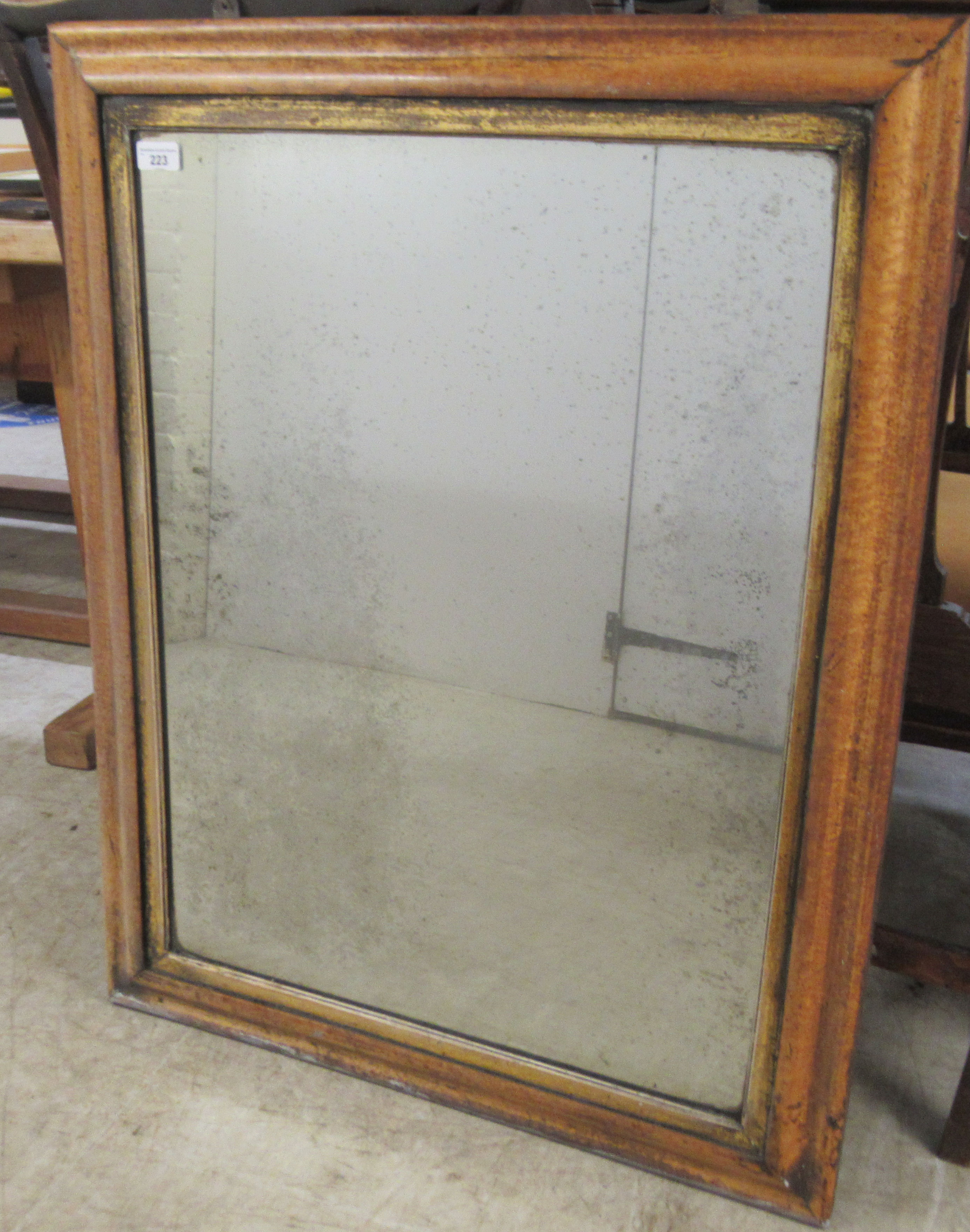A late 19thC mirror, the plate set in a moulded, simulated maple frame  28" x 35"