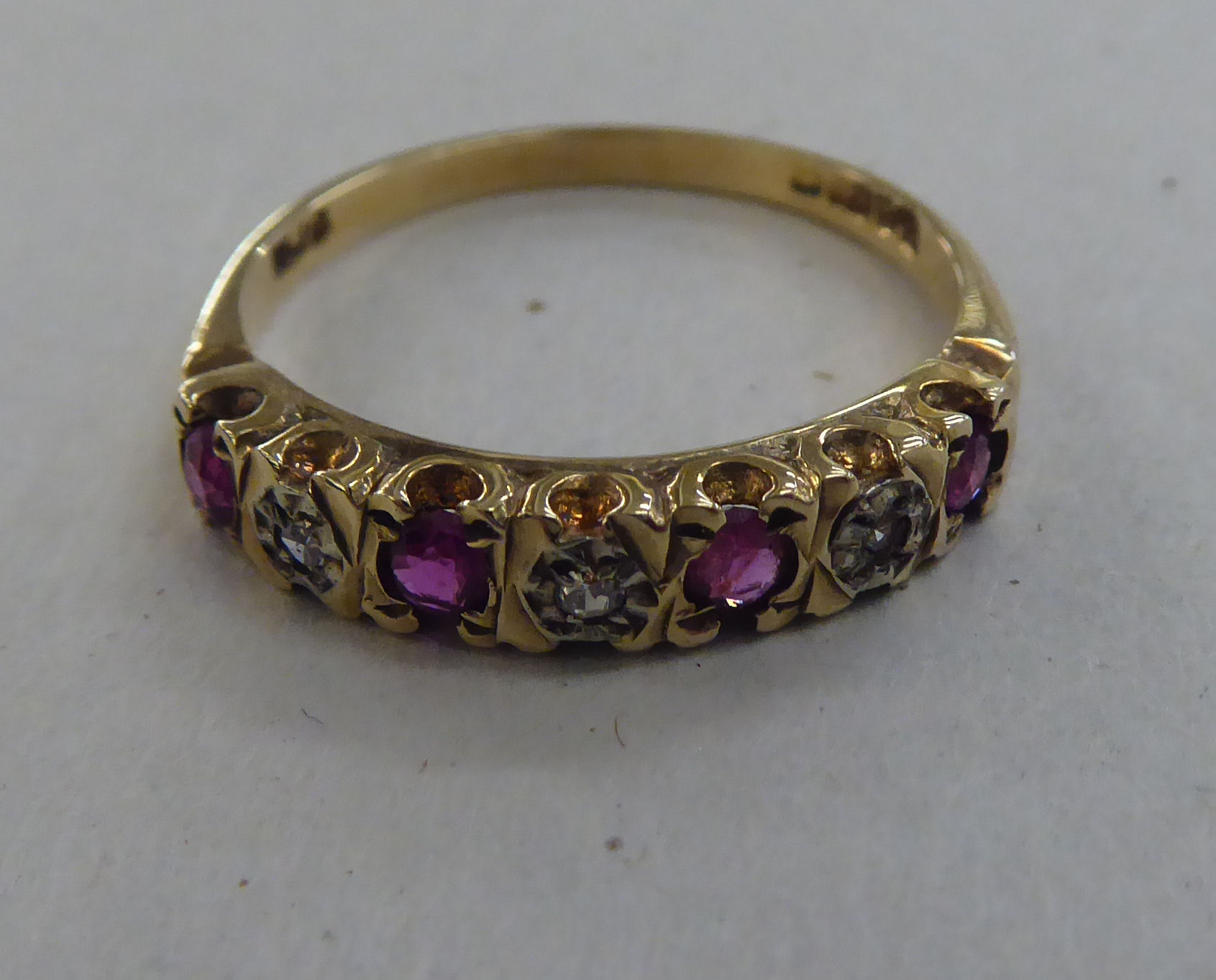 A 9ct gold eternity ring, set with alternating rubies and diamonds