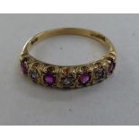A 9ct gold eternity ring, set with alternating rubies and diamonds