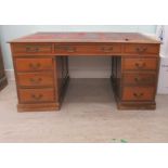 A mid 20thC mahogany nine drawer, twin pedestal desk, on a plinth  30"h  60"w