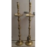 A pair of 20thC ecclesiastical brass candlesticks with spun columns, on circular bases  51"h