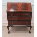 A mid 20thC mahogany finished bureau with a fall front, over three long drawers, raised on