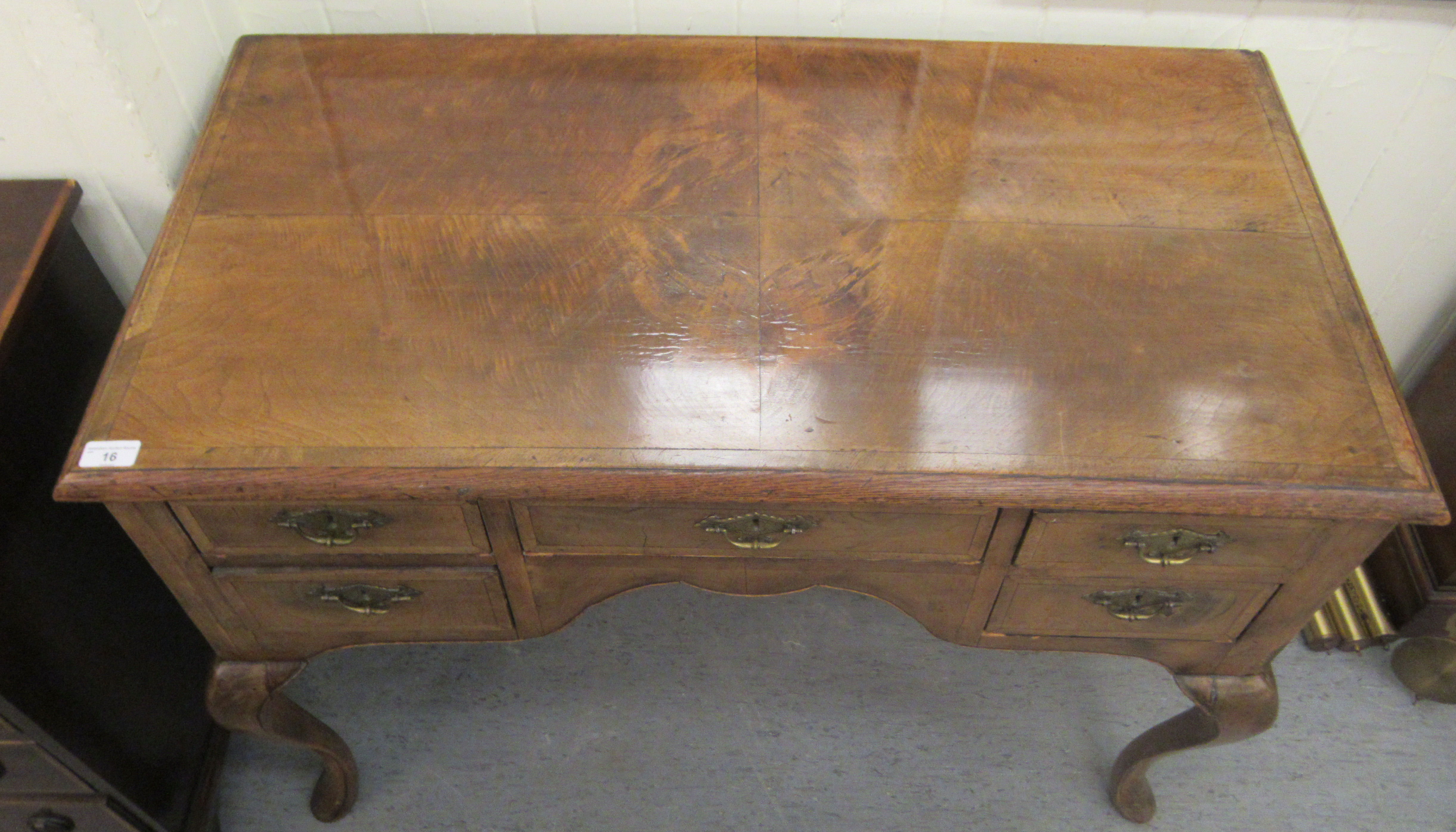 A late 19th/early 20thC crossbanded mahogany and walnut, five drawer kneehole desk, raised on - Image 2 of 5