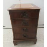 A modern mahogany finished two drawer filing cabinet, the top set with a tooled brown hide
