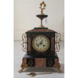 An early 20thC marble and black slate cased mantel clock, on lion paw feet; faced by an Arabic