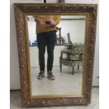 A modern bevelled mirror, set in an Art Nouveau inspired, moulded gilt frame  38" x 27"