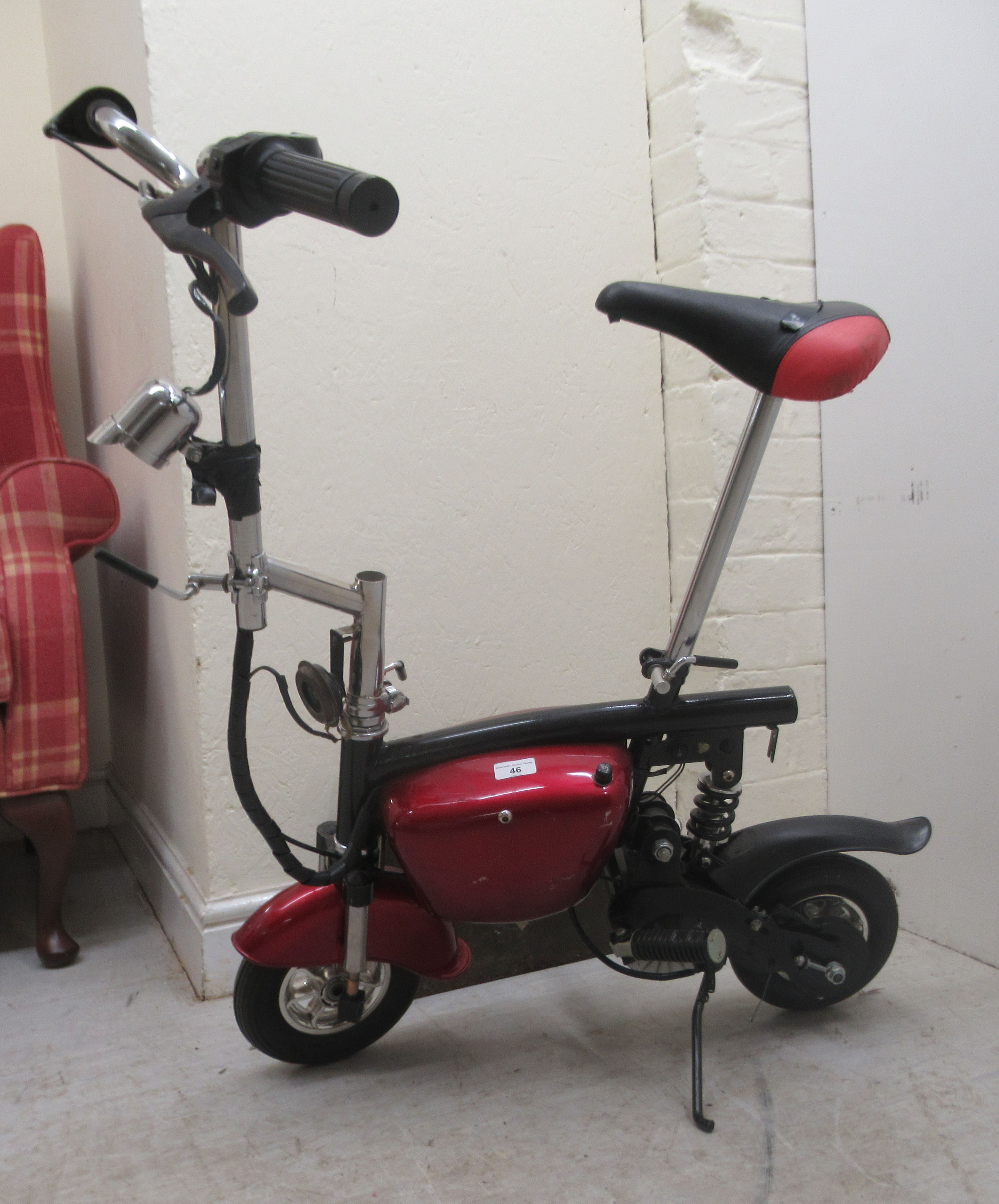 A modern battery powered bicycle with red livery and 8"wheels