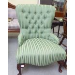 A Bright's of Nettlebed  button upholstered green fabric bedroom chair, raised on cabriole legs