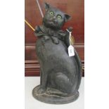 An early 20thC cast iron fire companion, fashioned as a black cat
