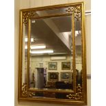 A modern mirror, the bevelled plate bordered by another plate, in a moulded gilt frame  31" x 44"