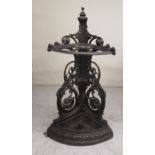 A Victorian style cast iron quadrant stickstand with a detachable drip tray and foliate scrolled