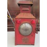 A Gyreclipse red painted cast metal railway lantern with a clear glass window and red reflectors