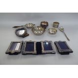 Silver collectables: to include a tea strainer; a pair of miniature photograph frames; and a pair of