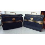 Two Hardy Amies black canvas and leather suit carrying cases