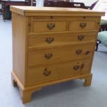 A modern pine dressing chest with a foldover top, over two short/three long drawers, raised on