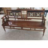 An early 20thC Colonial teak framed bench with a tiled back and a solid seat, raised on turned,
