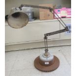 A vintage British made industrial adjustable workshop lamp, on a weighted base