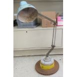 A vintage British made industrial adjustable workshop lamp, on a weighted base