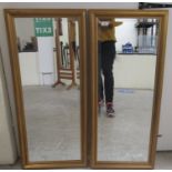 A pair of modern bevelled dressing mirrors, set in moulded gilt framed  37" x 17"