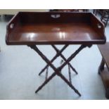 A George III mahogany butlers tray  30"w, on a later folding stand
