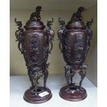 A pair of modern Japanese bronze censers with Dog of Fo finials, birds and grotesque mythical