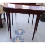 A Bright's of Nettlebed mahogany console table, raised on square, tapered legs  28"h  31"w