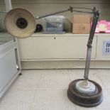 A vintage British made industrial adjustable workshop lamp, on a weighted base