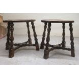 A pair of 19thC style oak framed low stools, the solid oval tops with cut-out handles, raised on