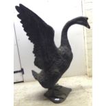 A cast and patinated green bronze model, a swan with outstretched wings, on a platform base  32"h
