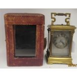An early 20thC lacquered brass cased carriage timepiece with reeded corner pilasters and a folding