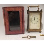 An early 20thC lacquered brass cased carriage timepiece with bevelled glass panels, reeded corner
