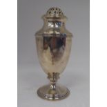 A silver caster of pedestal vase design with a perforated, domed cover  indistinct London maker's
