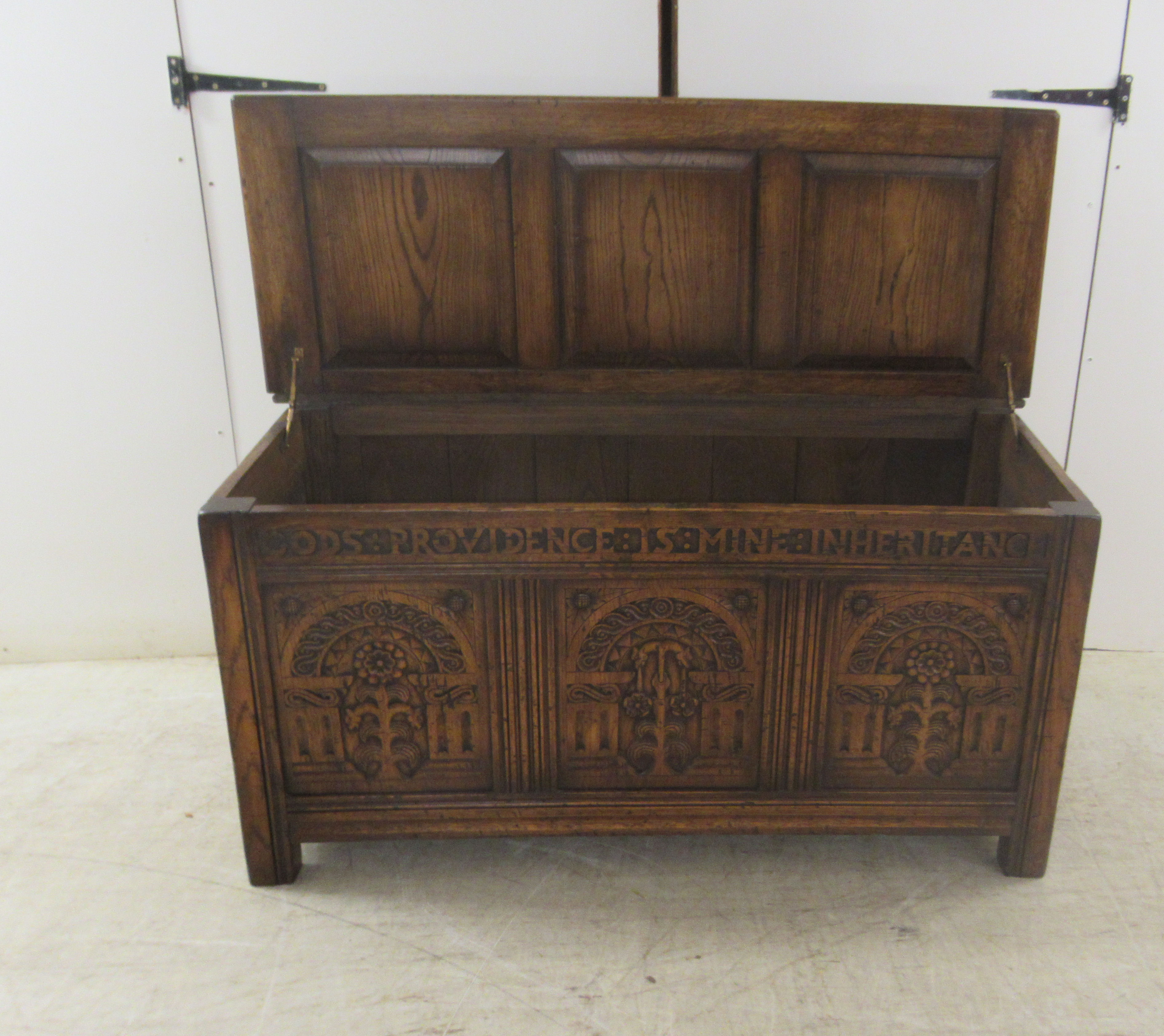 A Brights of Nettlebed period style, tri-panelled oak chest, the front with relief carved - Image 6 of 7