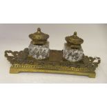 A late Victorian cast brass desktop inkstand, the decoratively pierced, twin handled tray base
