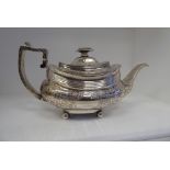 A George IV silver teapot of oval, ogee form with a swept spout and angular handle, flush fitting