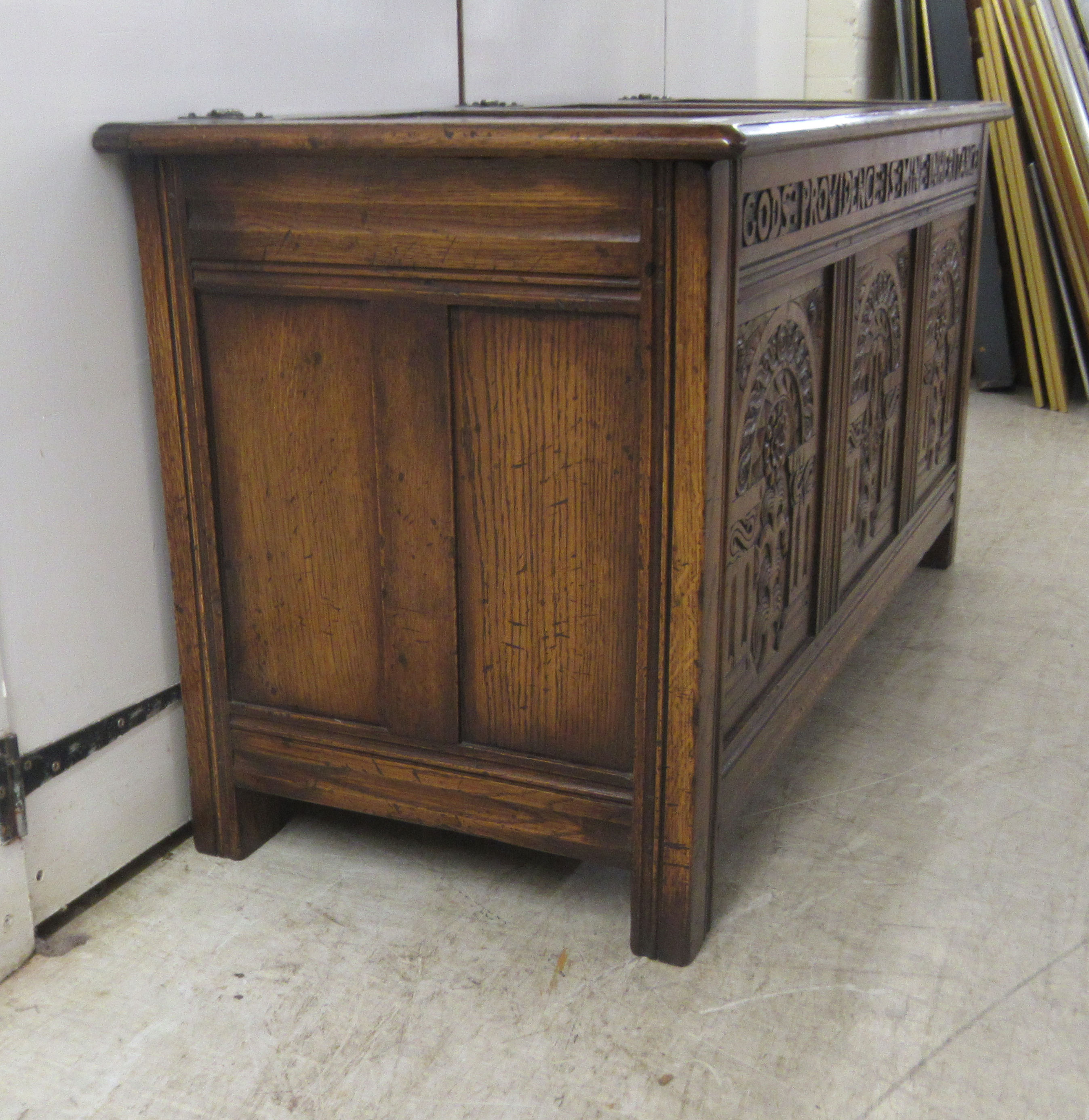 A Brights of Nettlebed period style, tri-panelled oak chest, the front with relief carved - Image 4 of 7