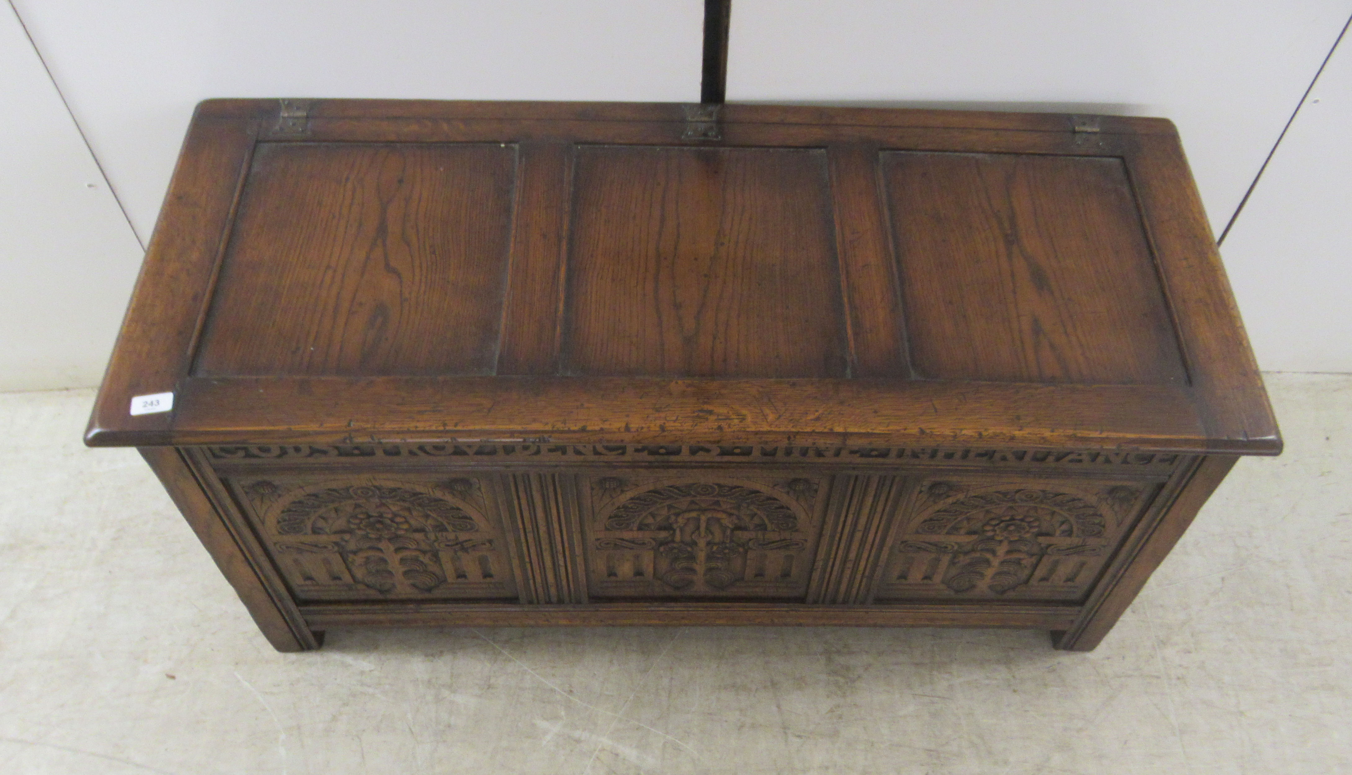 A Brights of Nettlebed period style, tri-panelled oak chest, the front with relief carved - Image 2 of 7