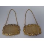 A pair of 9ct gold wine labels with shell cast and scrolled borders, on fine chains, inscribed '