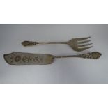 A mid Victorian silver fish slice and fork with ornately cast, pierced and engraved ornament  George