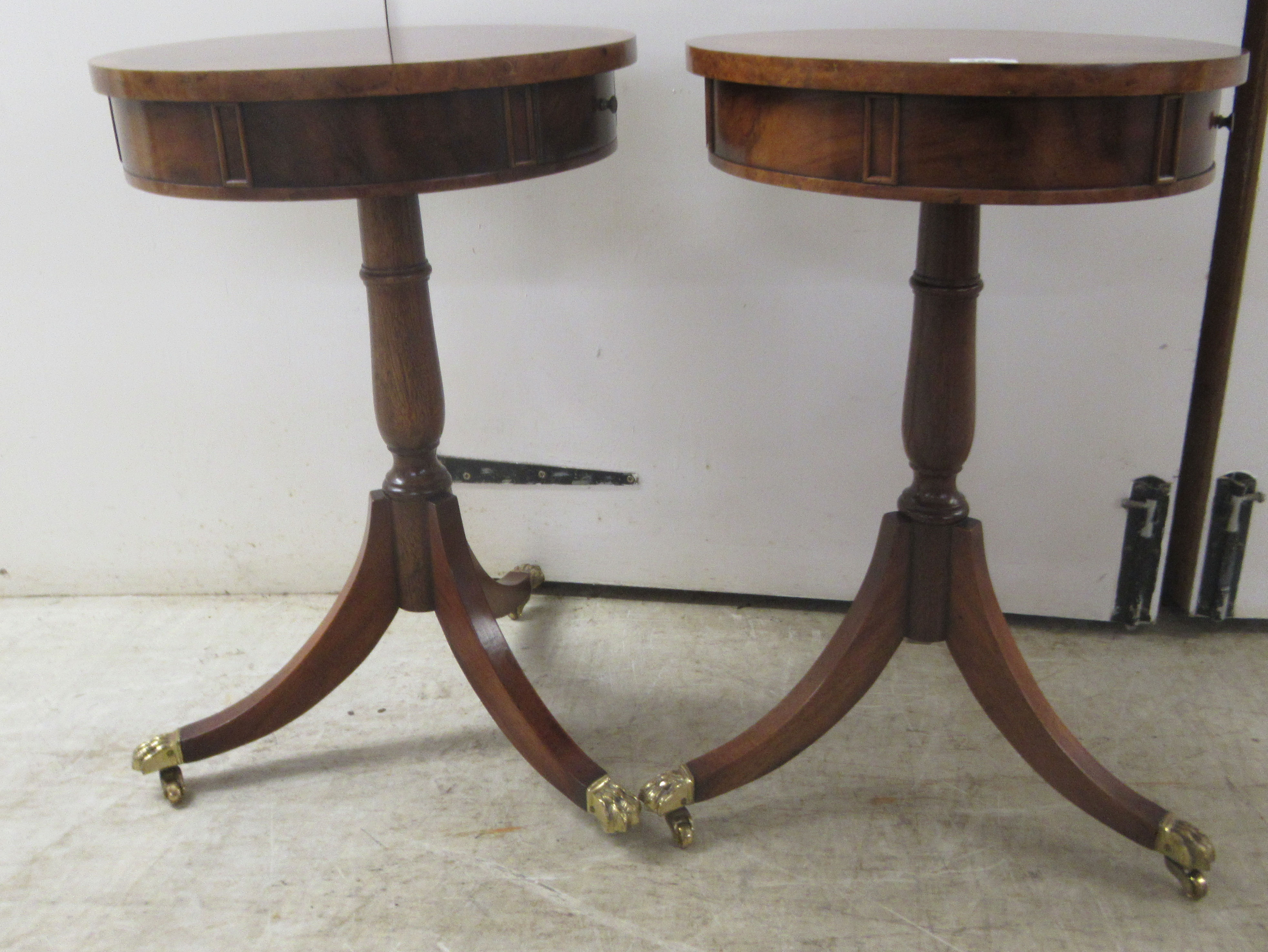 A pair of Brights of Nettlebed mahogany and walnut finished lamp tables, each with a frieze