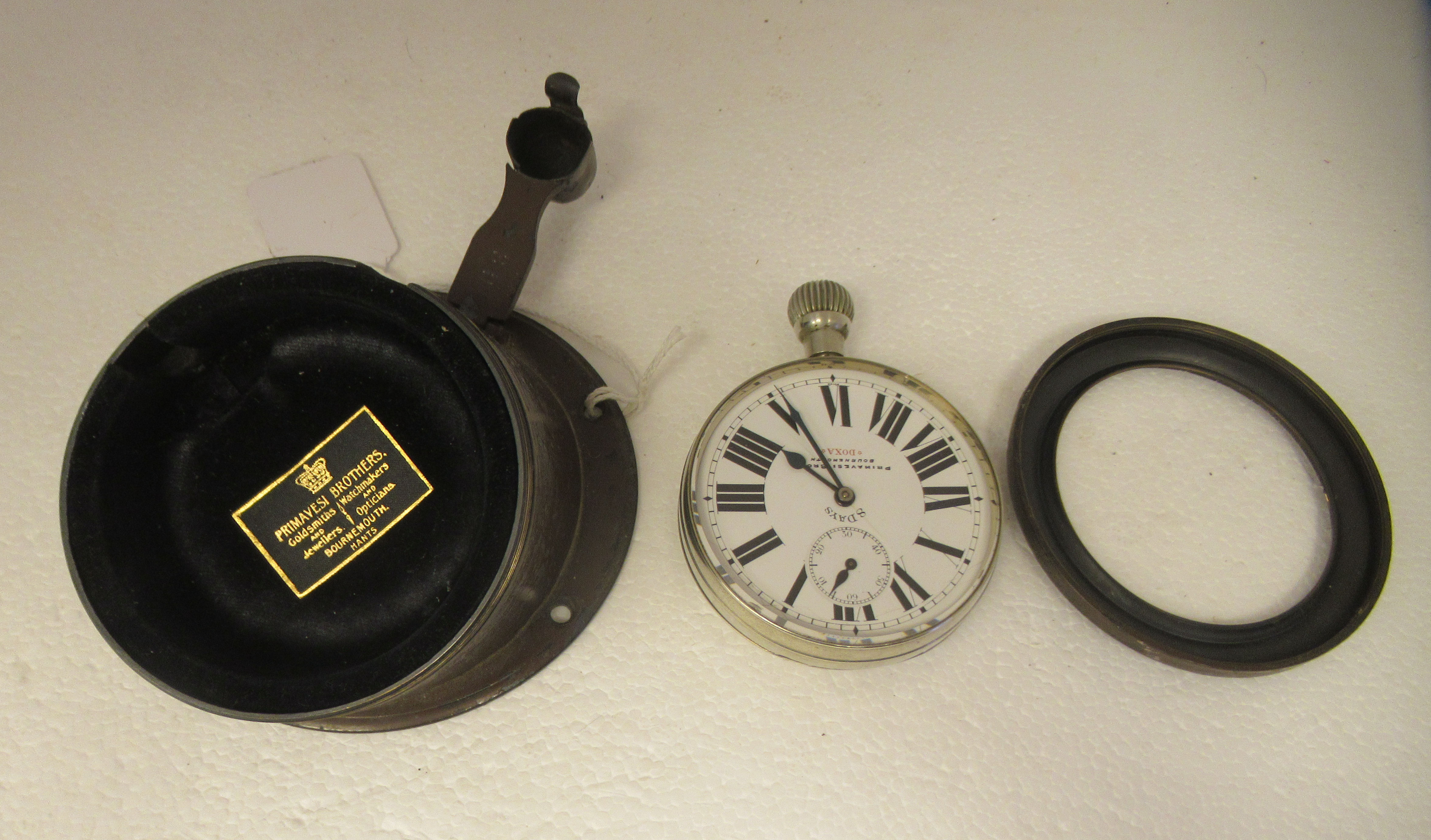 A vintage Doxa Argentan 8 day automobile dashboard timepiece, in a chocolate brown painted brass