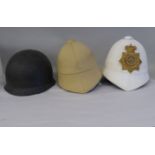 A white and a khaki regimental tropical helmet; and a US Army M1 helmet with liner (Please Note: