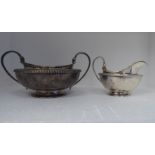A George III silver sugar basin of twin handled, shallow bowl design with a decoratively bead cast