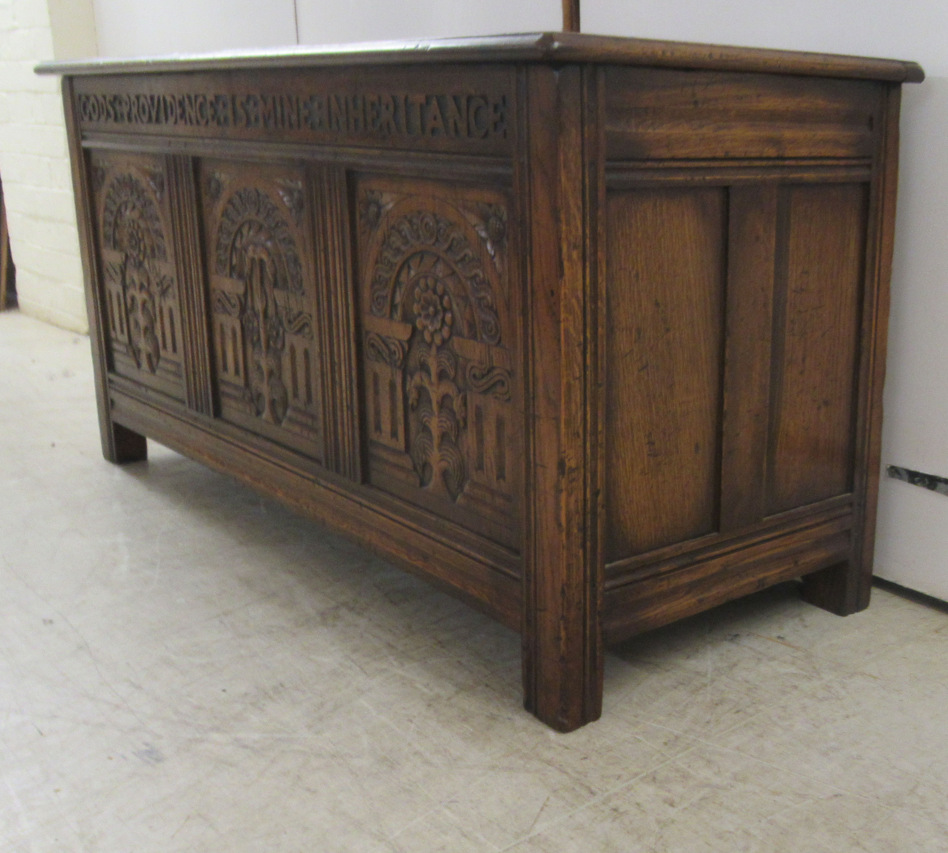 A Brights of Nettlebed period style, tri-panelled oak chest, the front with relief carved - Image 3 of 7